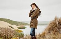 Woman standing in grass in Ariat jacket